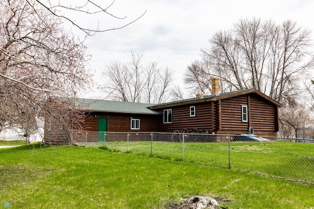 301 3rd Ave S, Borup, MN 56519 - back of property featuring fence, log exterior, a chimney, and a lawn