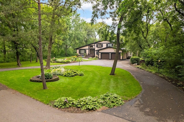 5853 Deer Trail Cir, Woodbury, MN 55129 - view of front facade featuring driveway, a front yard, an attached garage, and view of scattered trees
