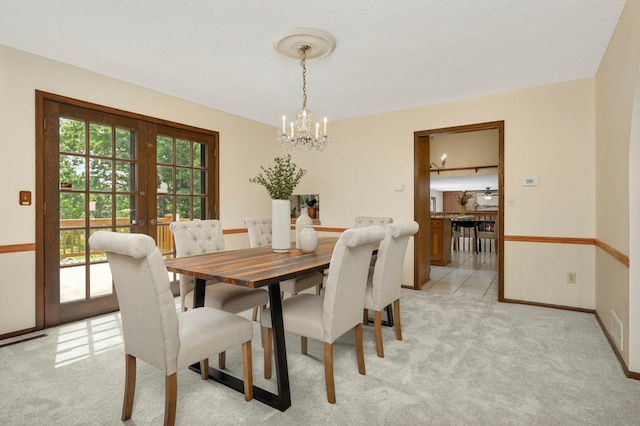 5853 Deer Trail Cir, Woodbury, MN 55129 - dining area with a chandelier, light carpet, and french doors