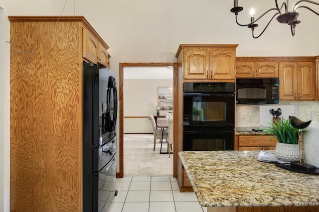 5853 Deer Trail Cir, Woodbury, MN 55129 - kitchen featuring black appliances, light stone counters, light tile patterned floors, a chandelier, and tasteful backsplash