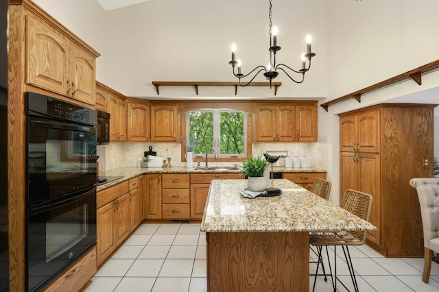 5853 Deer Trail Cir, Woodbury, MN 55129 - kitchen featuring black appliances, light tile patterned floors, a center island, tasteful backsplash, and light stone counters