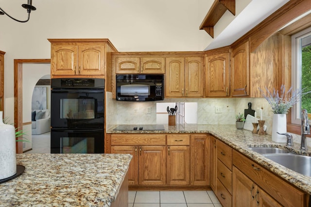 5853 Deer Trail Cir, Woodbury, MN 55129 - kitchen with black appliances, backsplash, and light stone counters