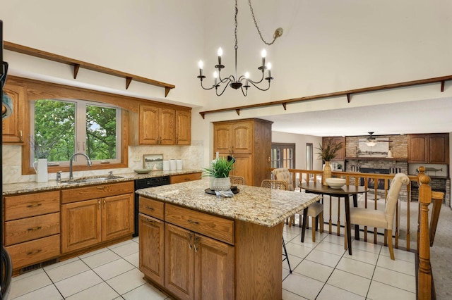 5853 Deer Trail Cir, Woodbury, MN 55129 - kitchen featuring a high ceiling, light tile patterned floors, backsplash, brown cabinets, and a kitchen island