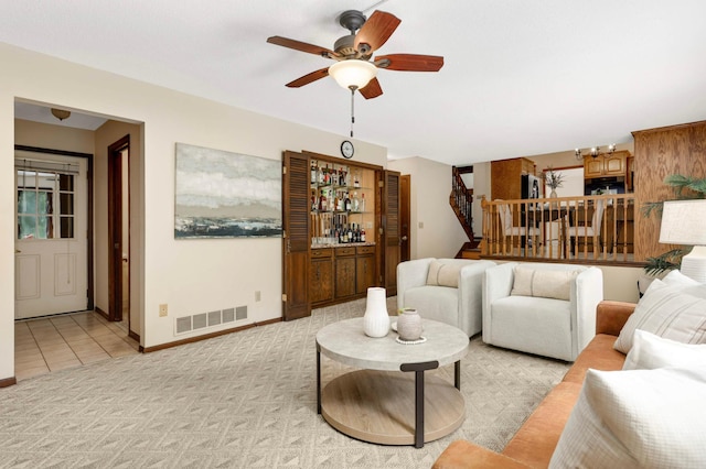 5853 Deer Trail Cir, Woodbury, MN 55129 - living room with stairs, ceiling fan, a dry bar, light tile patterned floors, and light colored carpet