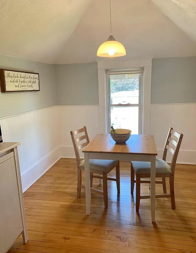 3600 17th Ave S Unit 301, Minneapolis, MN 55407 - dining space featuring light wood finished floors, vaulted ceiling, and wainscoting