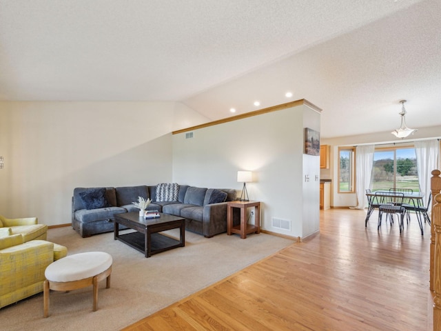 22184 Iman St NW, Nowthen, MN 55330 - living room featuring light wood-style floors, baseboards, and lofted ceiling