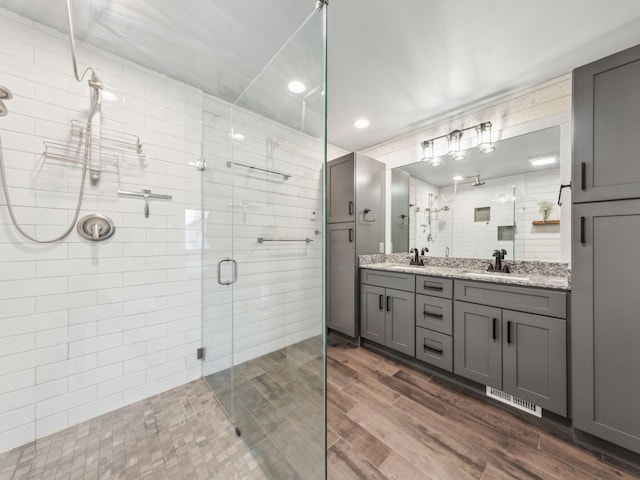 22184 Iman St NW, Nowthen, MN 55330 - full bath with a stall shower, double vanity, wood finished floors, and recessed lighting