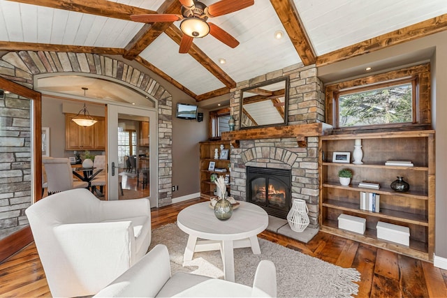 living room with a fireplace, a ceiling fan, wooden ceiling, vaulted ceiling with beams, and hardwood / wood-style flooring