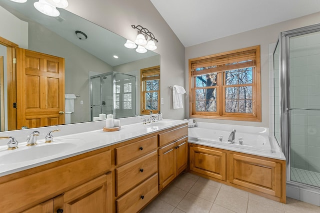 bathroom with a shower stall, tile patterned flooring, a sink, and lofted ceiling