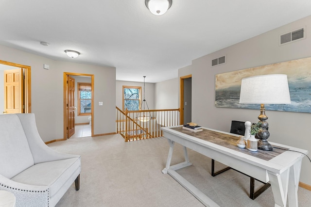 interior space with light colored carpet, baseboards, and visible vents