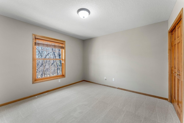 unfurnished bedroom with visible vents, baseboards, and carpet flooring