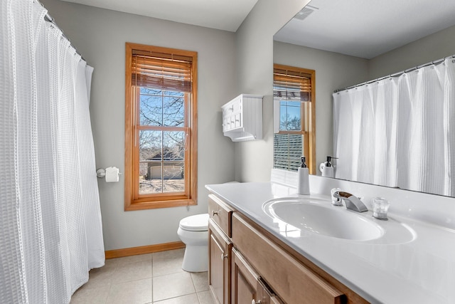 bathroom featuring toilet, tile patterned floors, visible vents, and a wealth of natural light