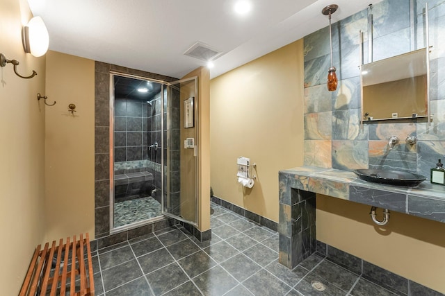 bathroom featuring visible vents, tile patterned floors, a stall shower, and baseboards