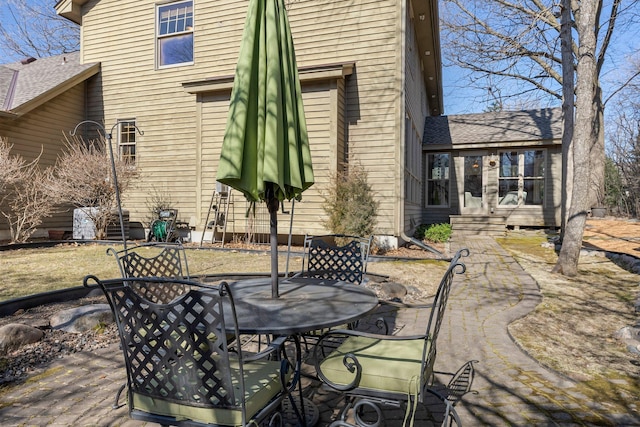exterior space featuring outdoor dining space and entry steps