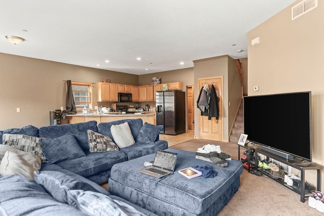 living room featuring light colored carpet, visible vents, and recessed lighting