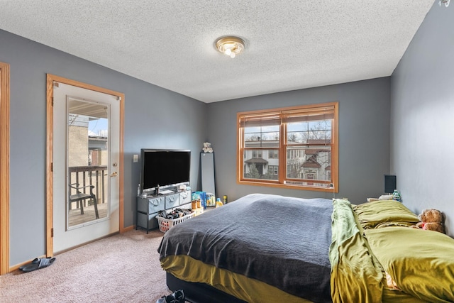 carpeted bedroom with baseboards and a textured ceiling