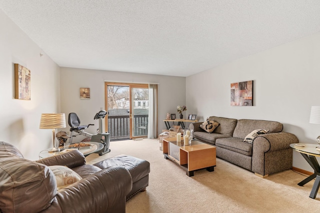 living room with a textured ceiling and light carpet