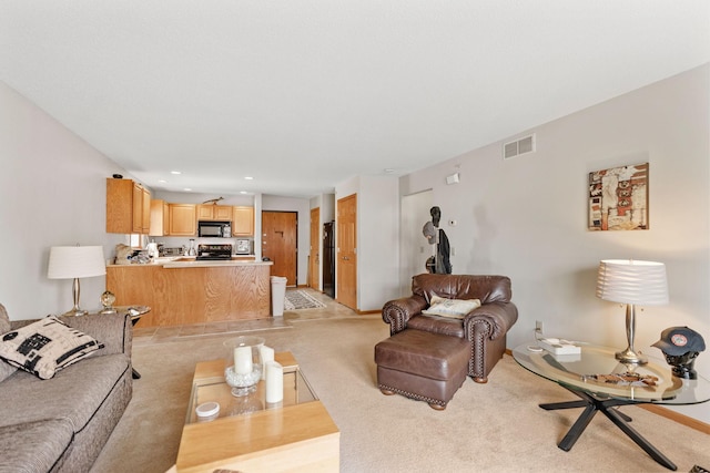 living area with recessed lighting, light colored carpet, and visible vents