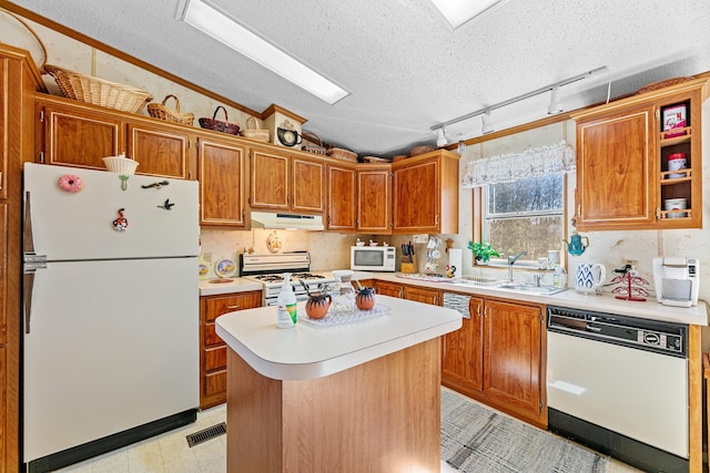 18482 Captive Lake Rd, Kathio Twp, MN 56450 - kitchen featuring white appliances, under cabinet range hood, a textured ceiling, vaulted ceiling, and light countertops