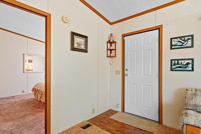 18482 Captive Lake Rd, Kathio Twp, MN 56450 - entryway with ornamental molding, lofted ceiling, and a textured ceiling