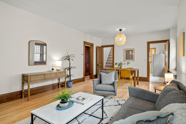 851 Watson Ave, Saint Paul, MN 55102 - living room featuring stairway, baseboards, and light wood-type flooring