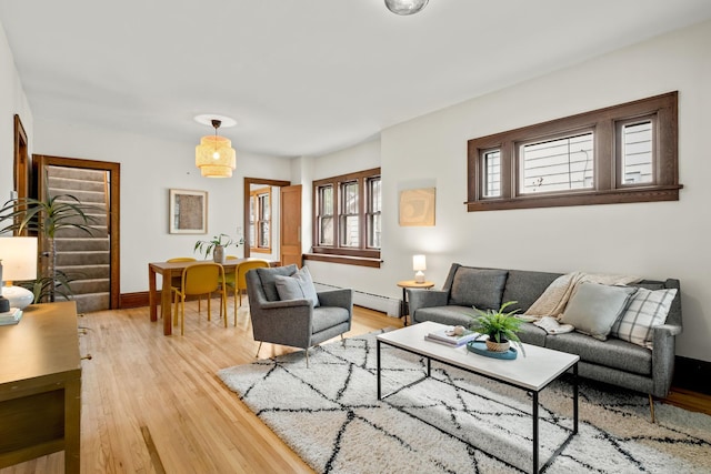 851 Watson Ave, Saint Paul, MN 55102 - living room with a baseboard heating unit, light wood-style flooring, and baseboards