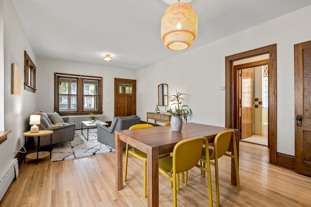 851 Watson Ave, Saint Paul, MN 55102 - dining room with baseboard heating, light wood-style floors, and radiator