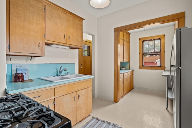 851 Watson Ave, Saint Paul, MN 55102 - kitchen with freestanding refrigerator, a sink, black gas range, light countertops, and baseboards