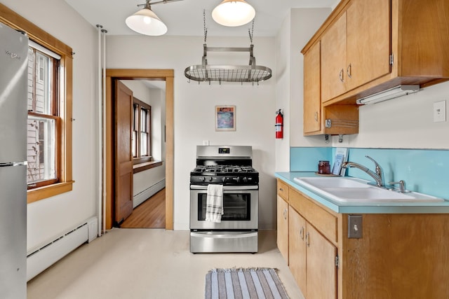 851 Watson Ave, Saint Paul, MN 55102 - kitchen featuring appliances with stainless steel finishes, a baseboard radiator, a sink, baseboard heating, and light countertops