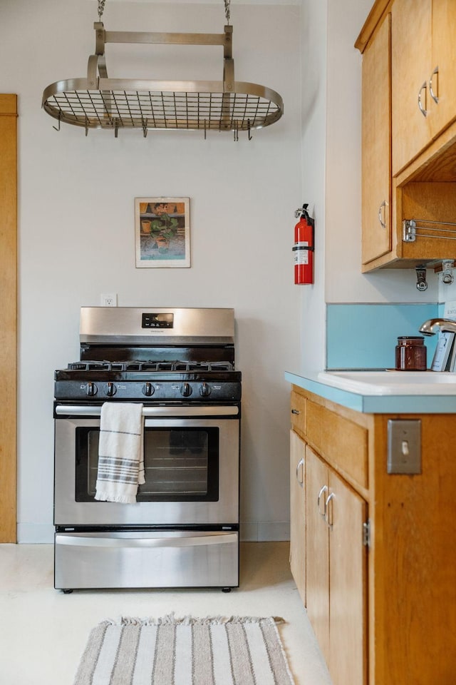 851 Watson Ave, Saint Paul, MN 55102 - kitchen featuring stainless steel gas range oven, light countertops, and a sink