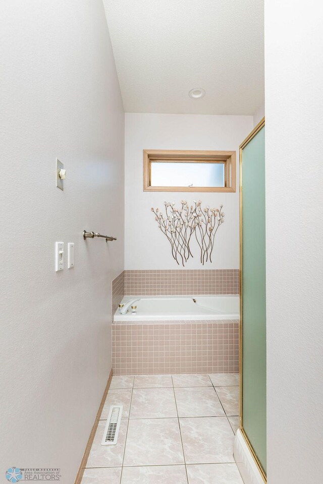 bathroom with a bath, visible vents, tile patterned floors, and a shower with door