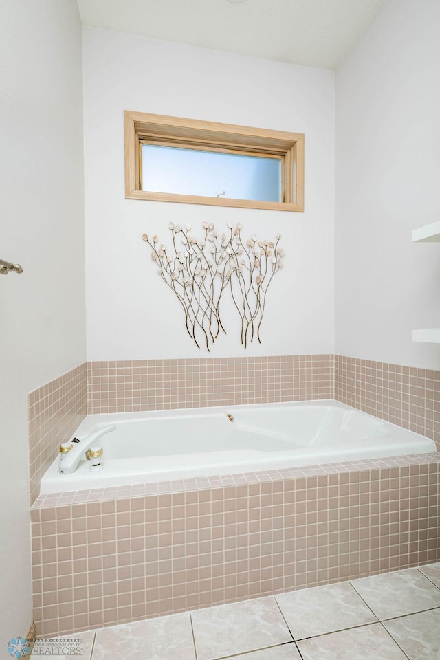 bathroom featuring tile patterned floors and a bath