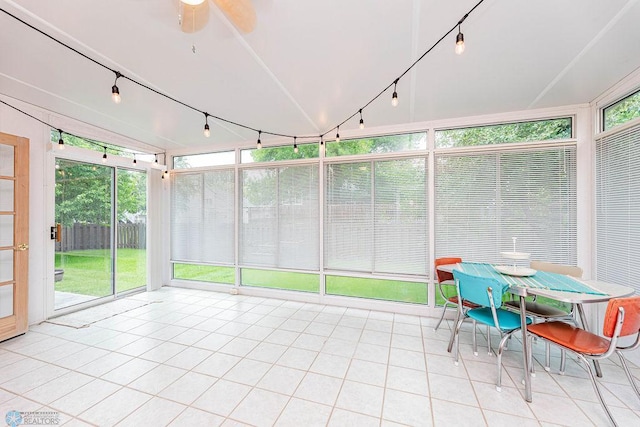 sunroom / solarium featuring tile patterned floors and track lighting