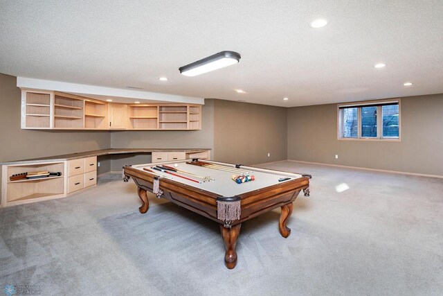 game room with baseboards, light carpet, built in desk, recessed lighting, and a textured ceiling