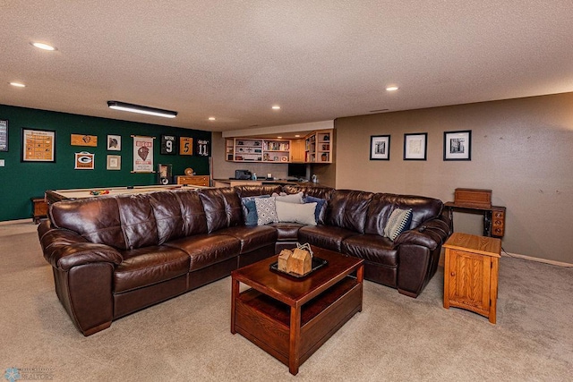 living room with baseboards, indoor bar, light colored carpet, recessed lighting, and a textured ceiling