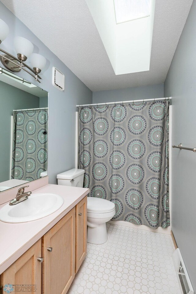 bathroom featuring vanity, toilet, a shower with curtain, and visible vents