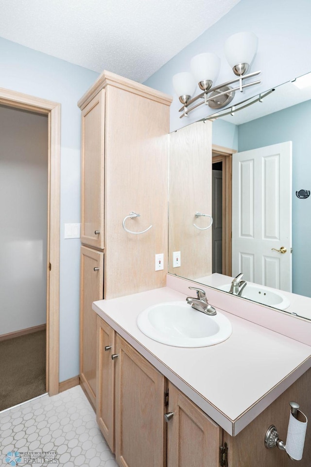 bathroom with baseboards and vanity
