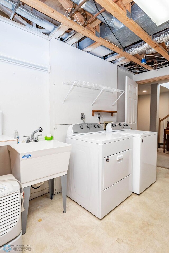 washroom featuring washer and clothes dryer and laundry area