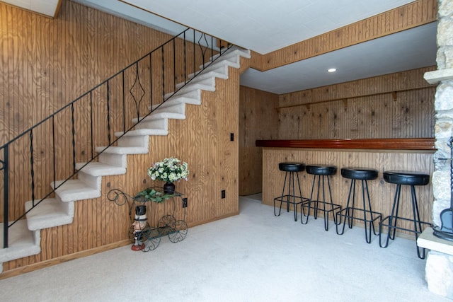 17639 Gayle Dr, Little Falls, MN 56345 - stairs with carpet floors, wood walls, and a bar