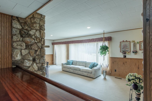 17639 Gayle Dr, Little Falls, MN 56345 - carpeted living room with wooden walls, visible vents, and a wainscoted wall