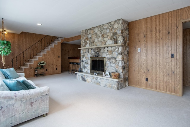 17639 Gayle Dr, Little Falls, MN 56345 - living area featuring carpet floors, a fireplace, baseboards, wooden walls, and stairway