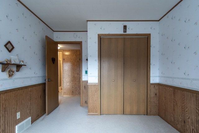 17639 Gayle Dr, Little Falls, MN 56345 - unfurnished bedroom with wooden walls, ornamental molding, wallpapered walls, and visible vents