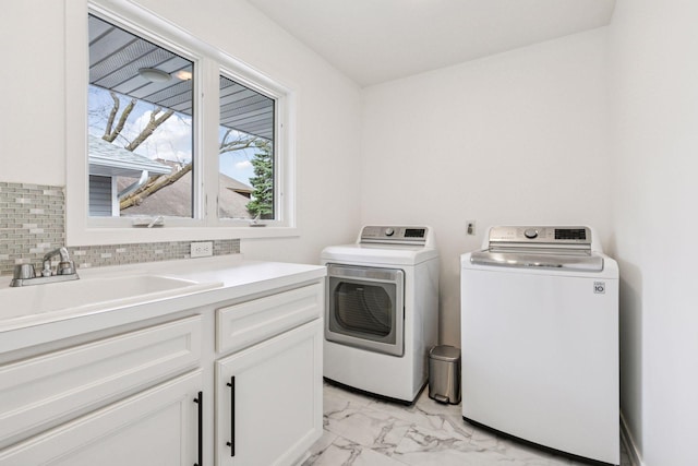 clothes washing area with marble finish floor, a sink, cabinet space, and washing machine and dryer