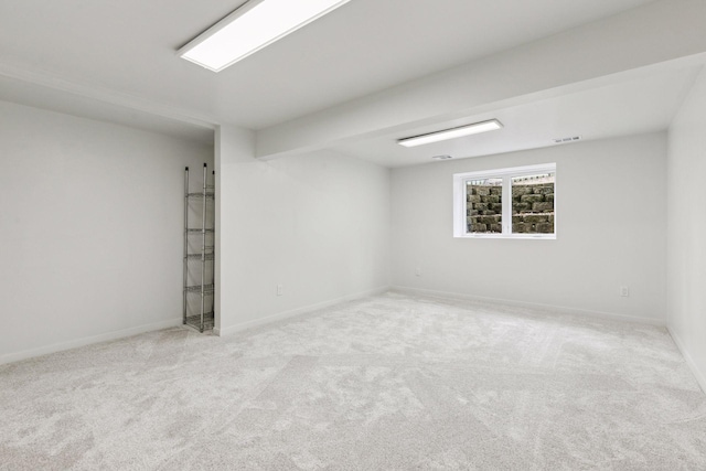 spare room with baseboards, visible vents, and carpet flooring