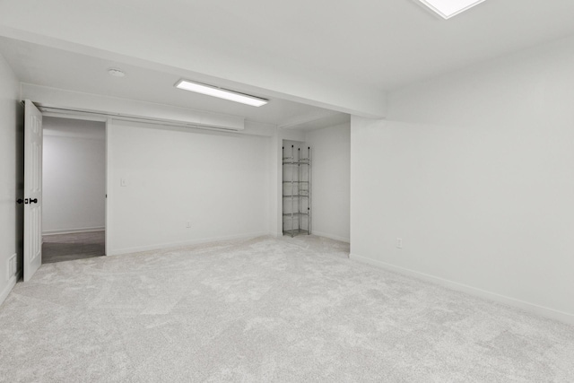interior space with light carpet and baseboards