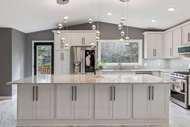 kitchen featuring marble finish floor, appliances with stainless steel finishes, lofted ceiling, a sink, and a spacious island