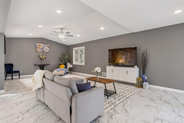 living room featuring a ceiling fan, baseboards, and vaulted ceiling