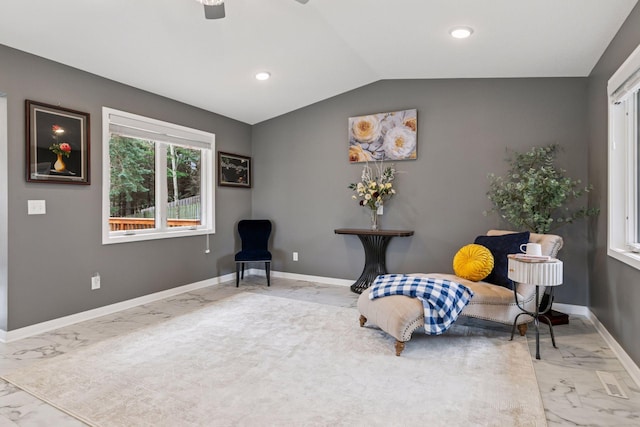 living area with marble finish floor, baseboards, lofted ceiling, and a ceiling fan