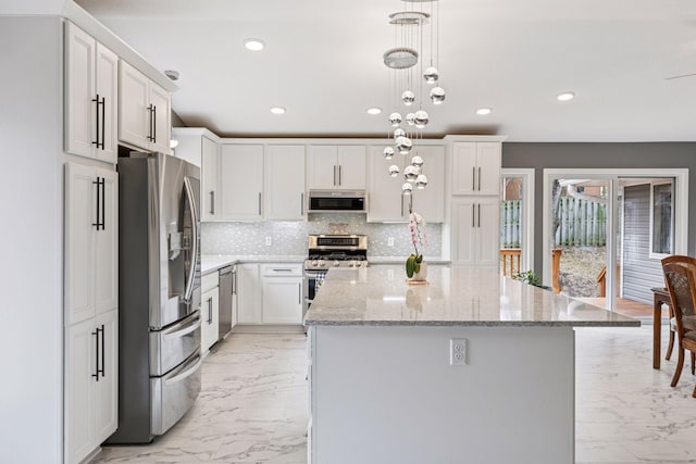kitchen featuring marble finish floor, decorative backsplash, a center island, and stainless steel appliances