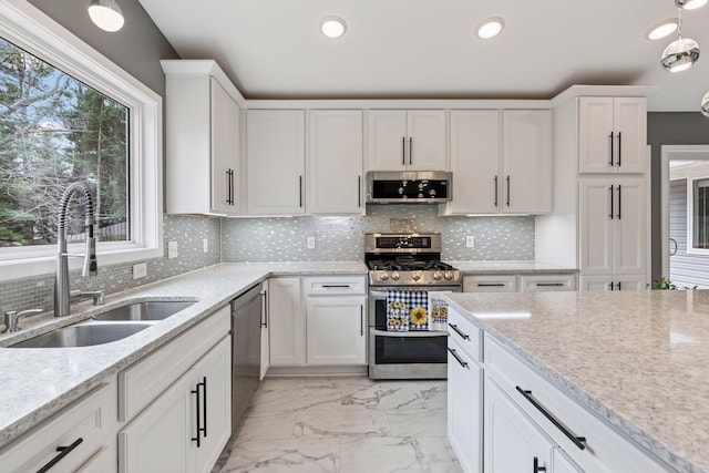 kitchen with marble finish floor, recessed lighting, appliances with stainless steel finishes, white cabinetry, and a sink